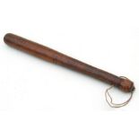 A turned wooden truncheon which has been weighted with a steel bar through the centre. Overall