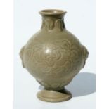 A Chinese Yaozhou celadon undercarved vase with lion mask handles and foliate decoration, 15cms