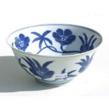 A Chinese blue & white bowl decorated with scrolling flowers, six character blue mark to the