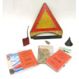 A red and yellow metal auto warning sign together with three oil cans, six German maps from the