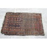 A Caucasian Shirvan rug with repeated geometric pattern on a brown ground, 102 by 170cms.