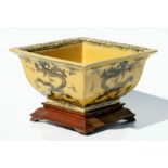 A Chinese square form bowl decorated with dragons on a yellow ground, blue six character mark to the