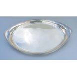 A large silver two-handled tray of heavy gauge, of navette form, makers Thomas of Bond Street,