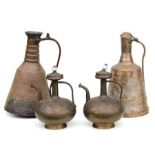 A pair of Middle Eastern brass ewers, 30cms high; together with a pair of large copper jugs, 43cms