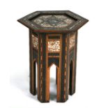 A Liberty style Islamic hexagonal occasional table with mother of pearl inlay, 43cms wide.