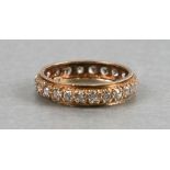 A 9ct gold eternity ring set with twenty four white stones approx UK size 'Q', weight 2.7g.