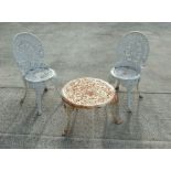 A pair of Colebrookdale style white painted cast aluminium chairs; together with a similar cast iron