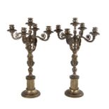 A pair of 19th century bronze four-branch candelabra, each with a column of an angel standing on