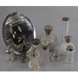 A large oval silver photo frame, Birmingham 1913; together with four silver mounted scent bottles