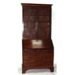 A George III mahogany bureau bookcase, the pair of astragal glazed doors above fall-flap with fitted