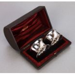 A pair of Victorian silver napkin rings, Birmingham 1887, weight 49g, cased.