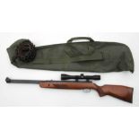 A German .22 air rifle with Hawke telescopic sight, canvas carrying bag and leather cartridge belt.