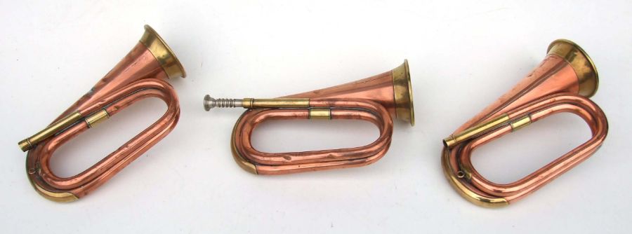 Three copper & brass military bugles, each approx 31cms long (3).