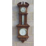 A Victorian architectural oak cased Negretti & Zambra wall mounted clock barometer thermometer,