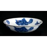 A Chinese blue & white shallow dish decorated with fish, 14cms diameter.