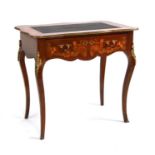 A French marquetry inlaid writing table, the shaped rectangular top with inset leather, ormolu