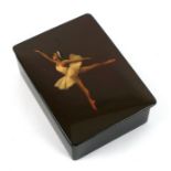 A Russian lacquered box and cover, the cover decorated with a ballerina, 16cms wide.