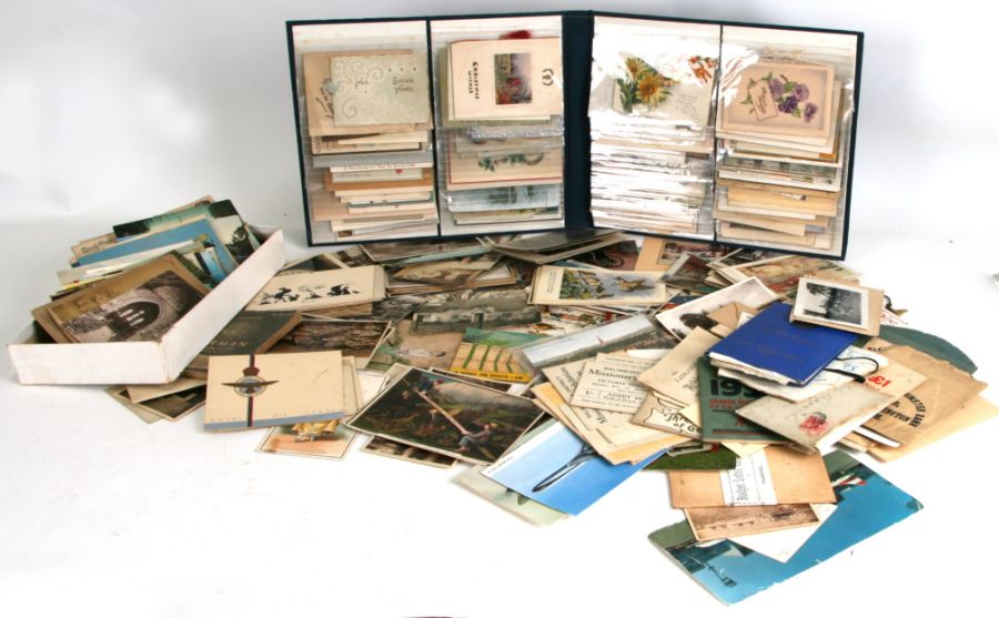 An album containing greeting cards; together with a quantity of topographical postcards and other