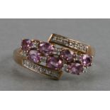 A 9ct gold dress ring set with diamonds and pink stones, weight 2.8g, approx UK size 'Q'.