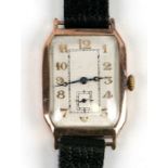 An Art Deco 9ct gold gentleman's wristwatch, the rectangular white dial with Arabic numerals,