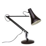 An Anglepoise Lighting Ltd Herbert Terry style Anglepoise lamp on a round base.