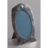 An Art Nouveau silver and enamel strut mirror of shaped rectangular form, with an enamel roundel