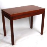 A 20th century teak fold-over card table, possibly military issue, on square legs, 92cms wide.