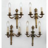 A pair of twin-arm brass wall lights; together with a quantity of similar wall lights.Condition