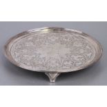 A George III silver salver with engraved decoration, on tripod legs, London 1790 and maker's mark