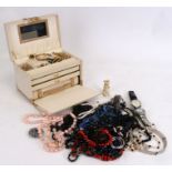 A quantity of costume jewellery in a white leather jewellery box
