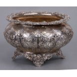 A mid 19th century silver bowl decorated with flowers, on four shell and lily pad feet, London