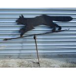 A well weathered steel weather vane in the form of a running fox, 118cms long.