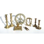 A 19th century brass range trivet; together with a pair of Victorian brass candlesticks and other