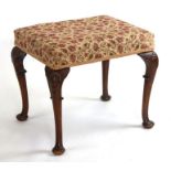 A George II style mahogany stool with upholstered seat, on shell capped cabriole legs and pad feet.