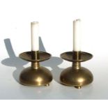 A pair of late 19th century continental brass candlesticks with large circular drip pans, 15cms