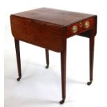 An early 19th century mahogany Pembroke table on square tapering legs terminating in brass