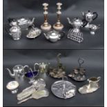 A large quantity of silver plate to include a pair of silver plated candlesticks, tea sets and other