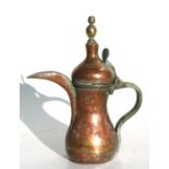 An Turkish / Islamic tinned copper dallah or coffee pot, 23cms high; together with another copper