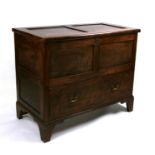 An oak mule chest with lift-up top above a single long drawer, on bracket feet, 104cms wide.