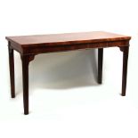 A 19th century mahogany serving table, the rectangular top on square tapering reeded legs, 128cms