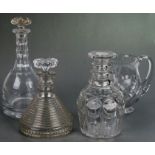 A 19th century cut glass ship's decanter, 18cms high; together with other decanters and a jug (4).