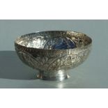 A Persian or Ottoman white metal footed bowl decorated with figures and flowers, 16cms diameter.