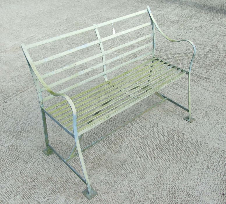 A distressed painted slatted metal garden bench, 123cms wide.