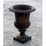 A cast iron urn of classical form, 31cms diameter.