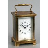 A French brass cased carriage time piece, the white dial with Roman numerals, 12cms high.
