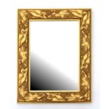 A modern gilt rectangular wall mirror decorated with leaves and berries, 45cms wide.