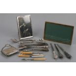 A quantity of silver handled cutlery, button hooks and shoehorns; together with two silver photo