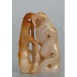A Chinese figured jade / hardstone carving in the form of a bird perched on a rock beside bamboo,