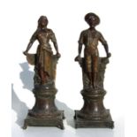 After A Rucho, a pair of French bronzed spelter figures, 30cms high (2).