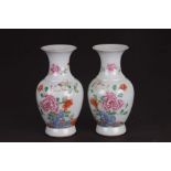 A pair of Chinese famille rose vases decorated with flowers, red seal mark to the back of the